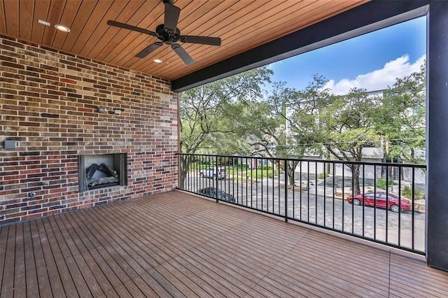 wooden terrace featuring ceiling fan