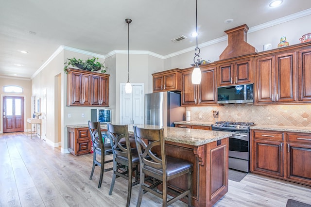 kitchen featuring light stone counters, visible vents, stainless steel appliances, light wood-style floors, and backsplash