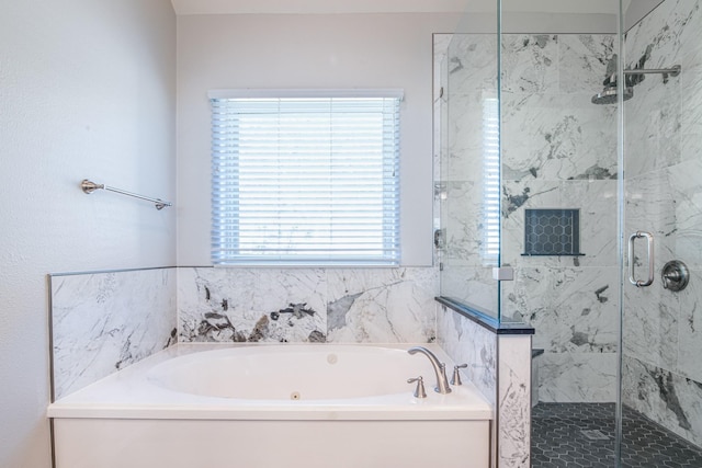 bathroom featuring a bath and a stall shower