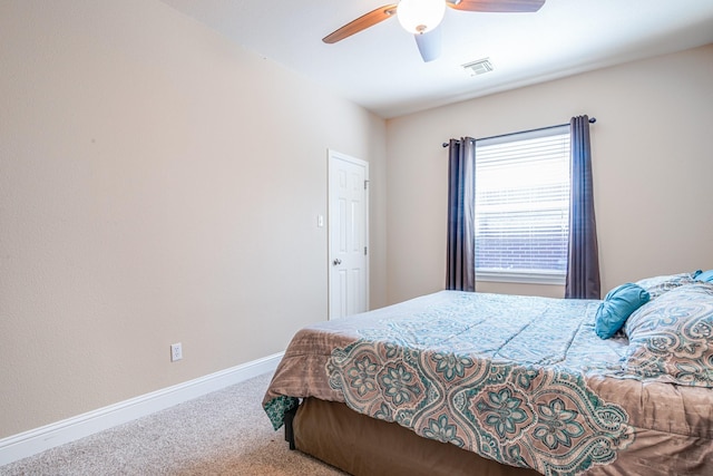 bedroom with visible vents, baseboards, carpet, and a ceiling fan