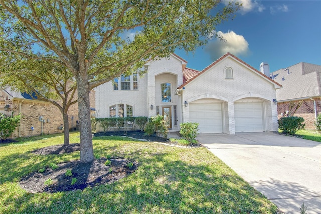 view of front of home with a garage, concrete driveway, brick siding, and a front lawn