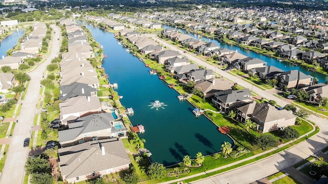 drone / aerial view featuring a water view and a residential view