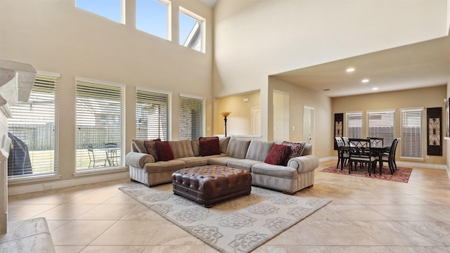 living room featuring plenty of natural light, baseboards, and light tile patterned floors