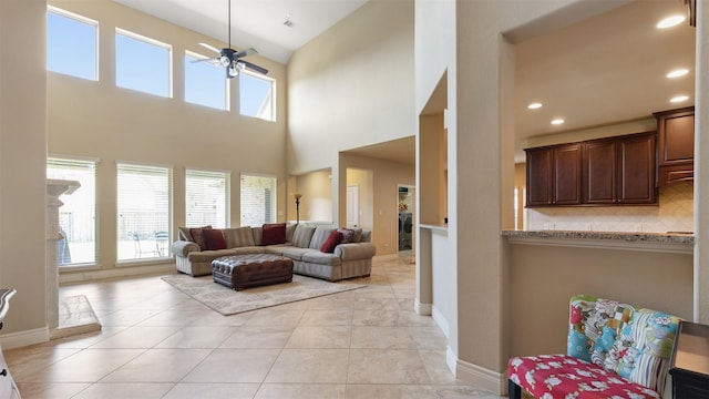 living room featuring light tile patterned flooring, recessed lighting, baseboards, and ceiling fan