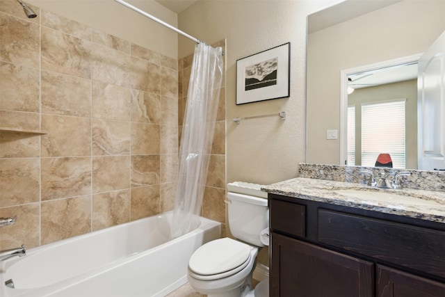 bathroom with shower / bathtub combination with curtain, toilet, vanity, and a textured wall