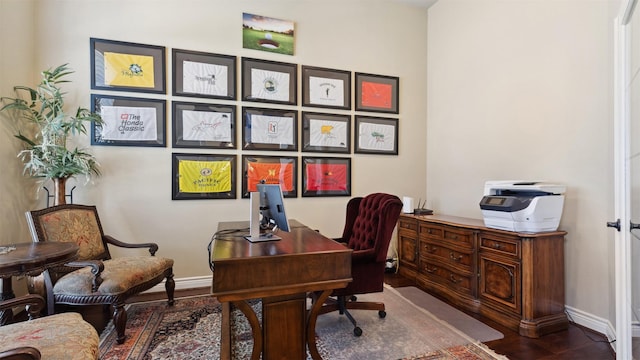 office area featuring baseboards and wood finished floors