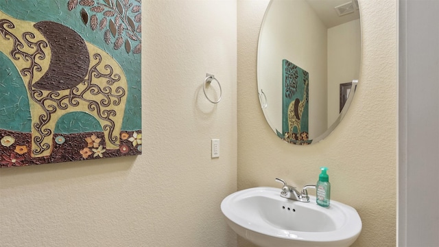 bathroom with a sink and visible vents