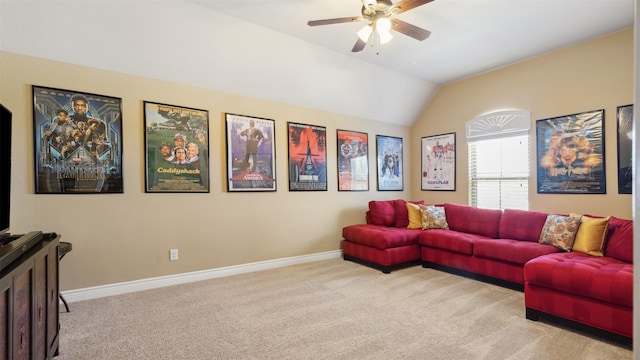 living area featuring carpet flooring, ceiling fan, baseboards, and lofted ceiling