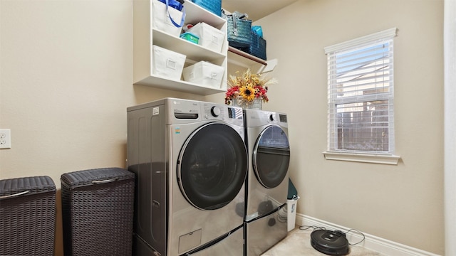 washroom with washer and clothes dryer, laundry area, and baseboards