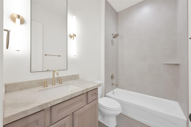 bathroom featuring shower / bathing tub combination, vanity, toilet, and tile patterned floors