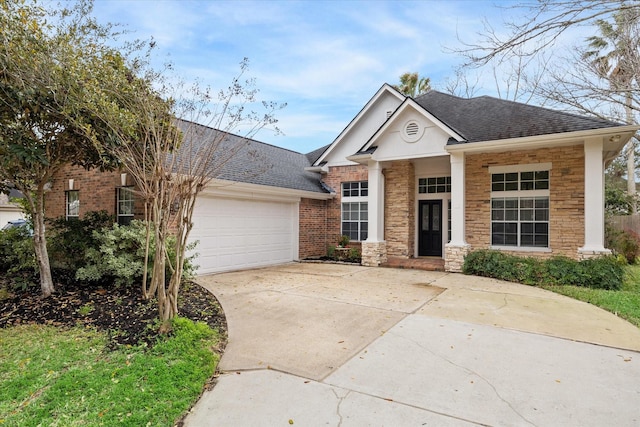 view of front facade featuring a garage, concrete driveway, roof with shingles, and brick siding