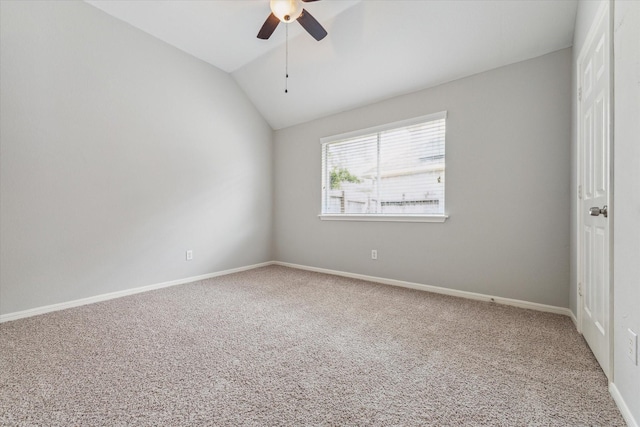 empty room featuring a ceiling fan, lofted ceiling, carpet flooring, and baseboards