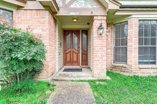 entrance to property with brick siding