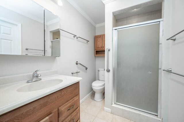 full bathroom featuring ornamental molding, a stall shower, tile patterned flooring, and vanity