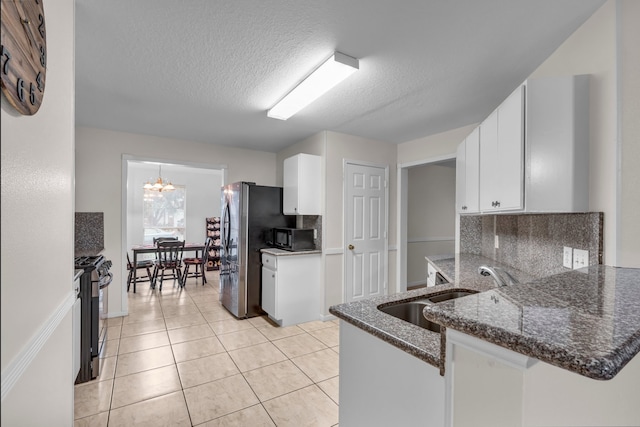 kitchen featuring white cabinets, a sink, backsplash, and black appliances