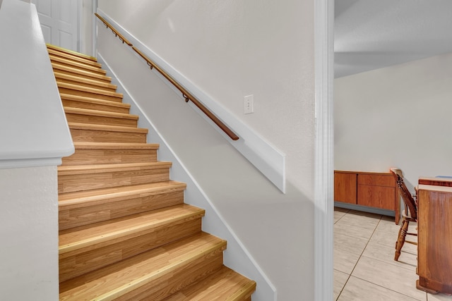 stairway with tile patterned floors