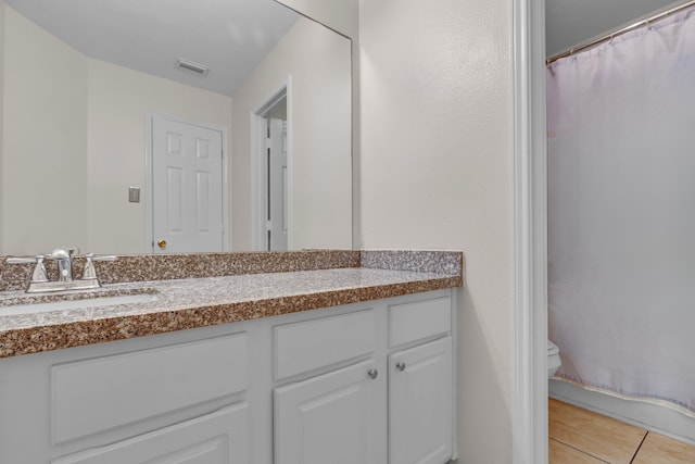 full bathroom featuring visible vents, vanity, toilet, and tile patterned floors