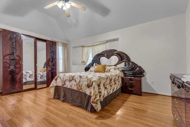 bedroom featuring lofted ceiling, wood finished floors, access to exterior, and baseboards