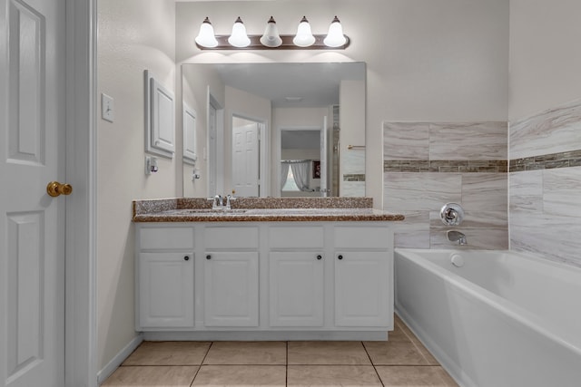 full bathroom featuring tile patterned flooring, a garden tub, and vanity