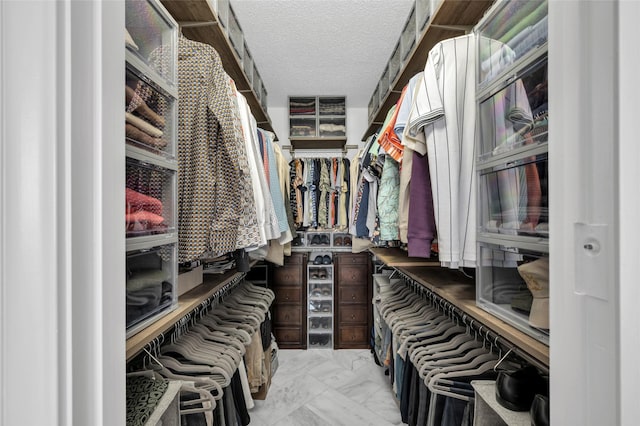 spacious closet with marble finish floor