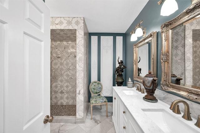 bathroom featuring double vanity, marble finish floor, a walk in shower, and a sink