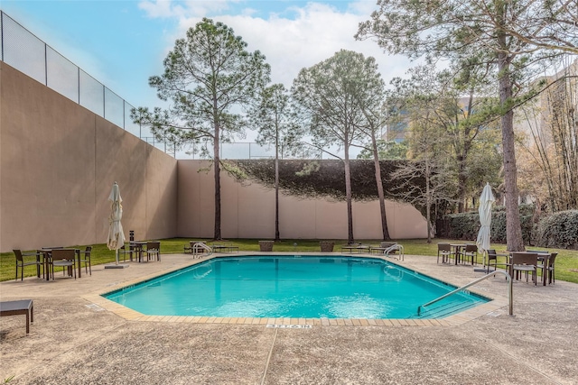 view of pool with a fenced in pool, a yard, a fenced backyard, and a patio