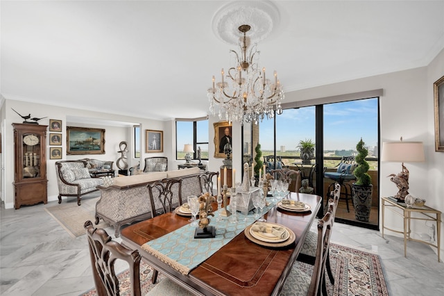 dining room with baseboards, marble finish floor, ornamental molding, and an inviting chandelier