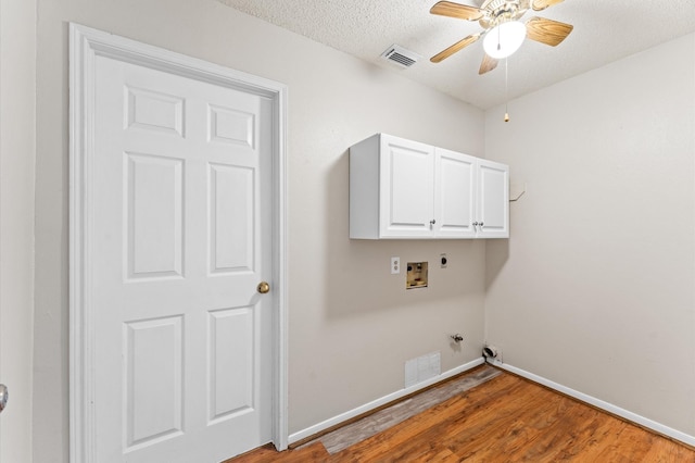 washroom with visible vents, washer hookup, light wood-style flooring, cabinet space, and gas dryer hookup