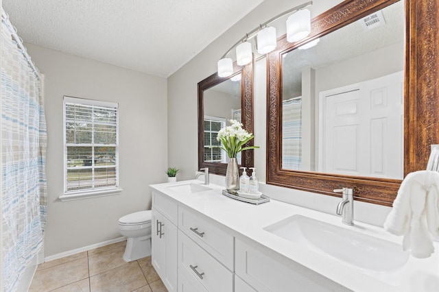 full bathroom with tile patterned floors, visible vents, toilet, a sink, and a textured ceiling