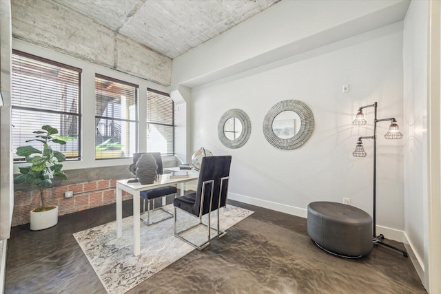 home office with baseboards and concrete floors