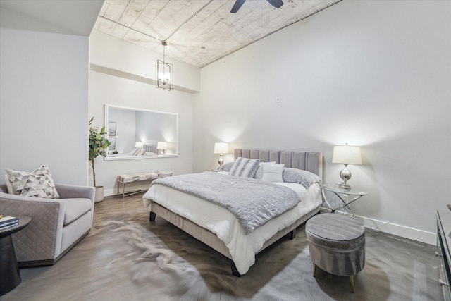 bedroom with finished concrete flooring and baseboards