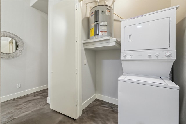 laundry area with baseboards, stacked washer and clothes dryer, water heater, and laundry area