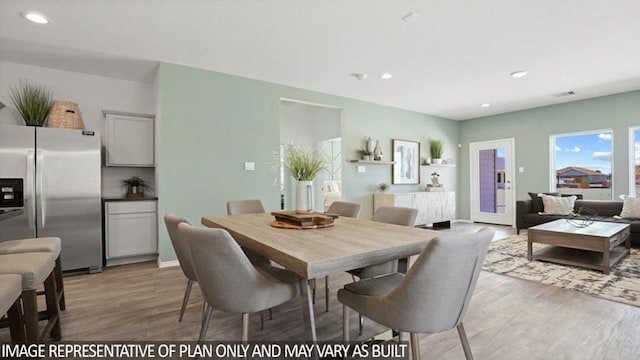 dining room with light wood-style floors and recessed lighting