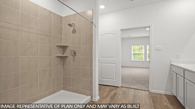 1507 Portia Ct, Conroe, TX 77301 - full bath featuring wood finished floors, tiled shower, vanity, and recessed lighting