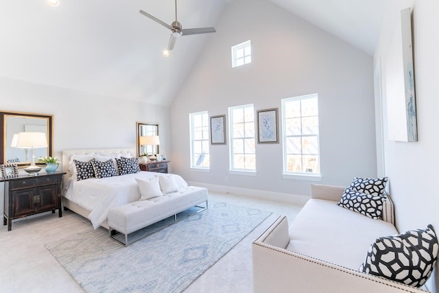 bedroom with high vaulted ceiling, multiple windows, and baseboards