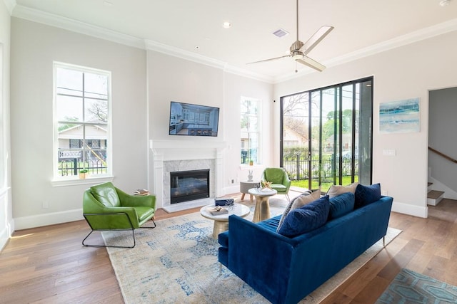 living room featuring ornamental molding, stairway, and wood-type flooring