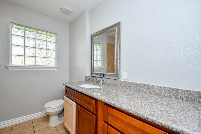 bathroom featuring tile patterned floors, visible vents, vanity, and a wealth of natural light