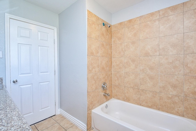 bathroom with tile patterned flooring, shower / bathing tub combination, and baseboards