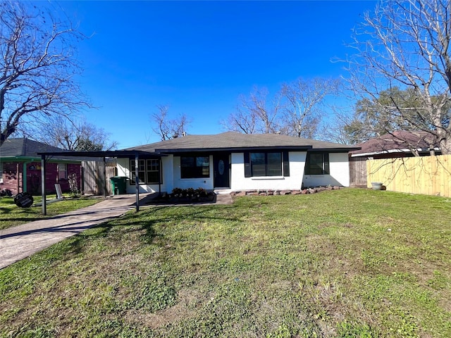 ranch-style home featuring a front lawn, fence, and driveway