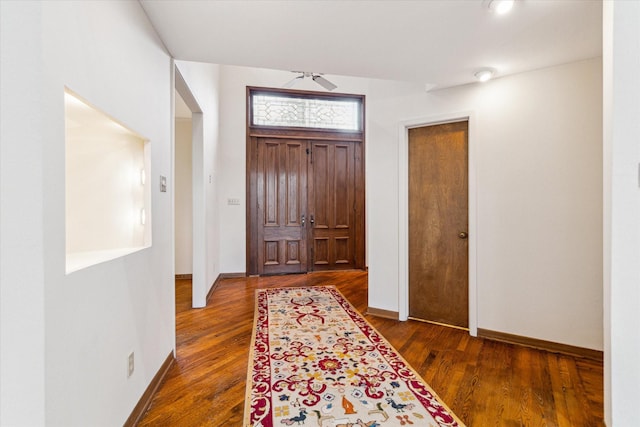 entrance foyer with ceiling fan, wood finished floors, and baseboards