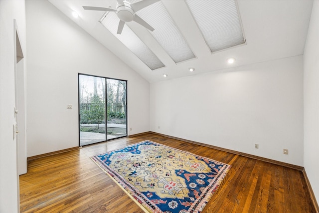 spare room featuring ceiling fan, high vaulted ceiling, wood finished floors, and baseboards