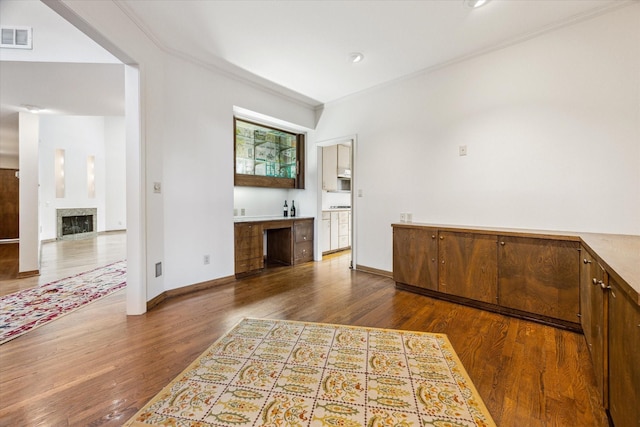 interior space featuring ornamental molding, dark wood finished floors, and visible vents