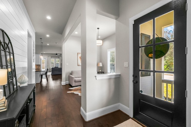 foyer entrance featuring recessed lighting, baseboards, and dark wood-type flooring