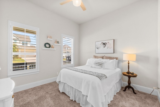 bedroom with light carpet, a ceiling fan, and baseboards