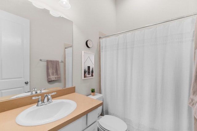 full bathroom with vanity, a shower with shower curtain, and toilet