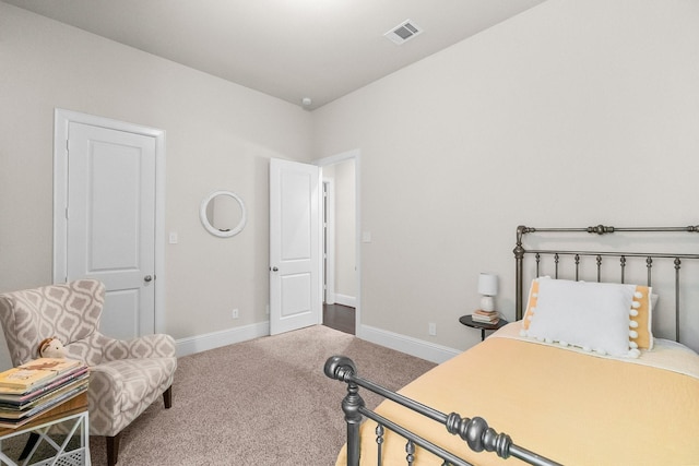 carpeted bedroom featuring baseboards and visible vents