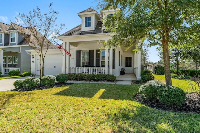 view of front of home featuring a garage, covered porch, concrete driveway, and a front yard