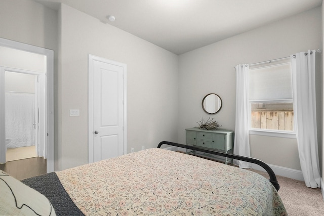 carpeted bedroom featuring baseboards