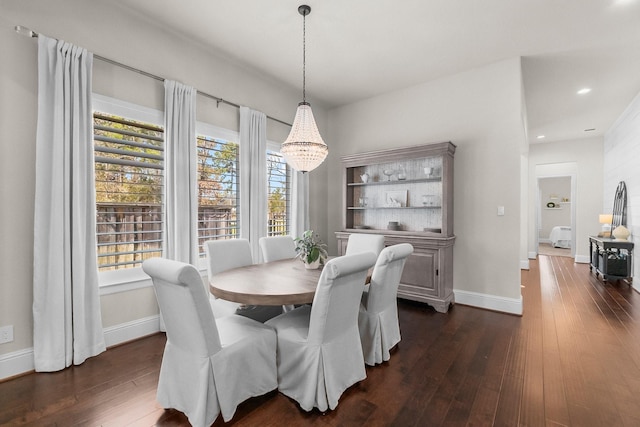 dining space featuring dark wood-type flooring, plenty of natural light, and baseboards