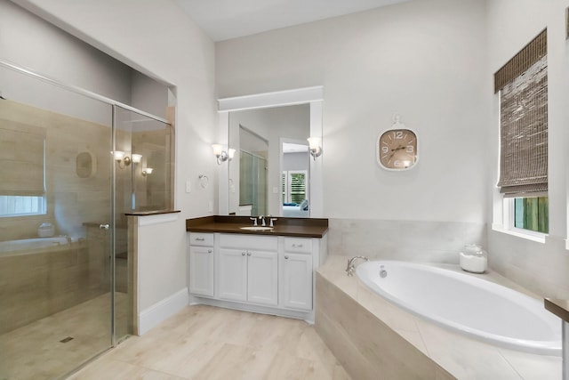 full bath with a garden tub, vanity, and a shower stall